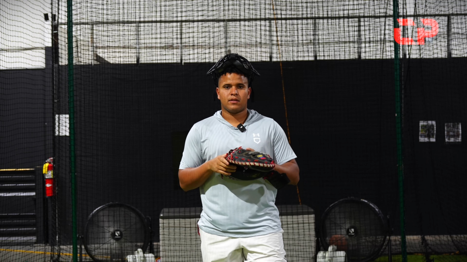 Coach Andrés talking to the camera while holding his glove