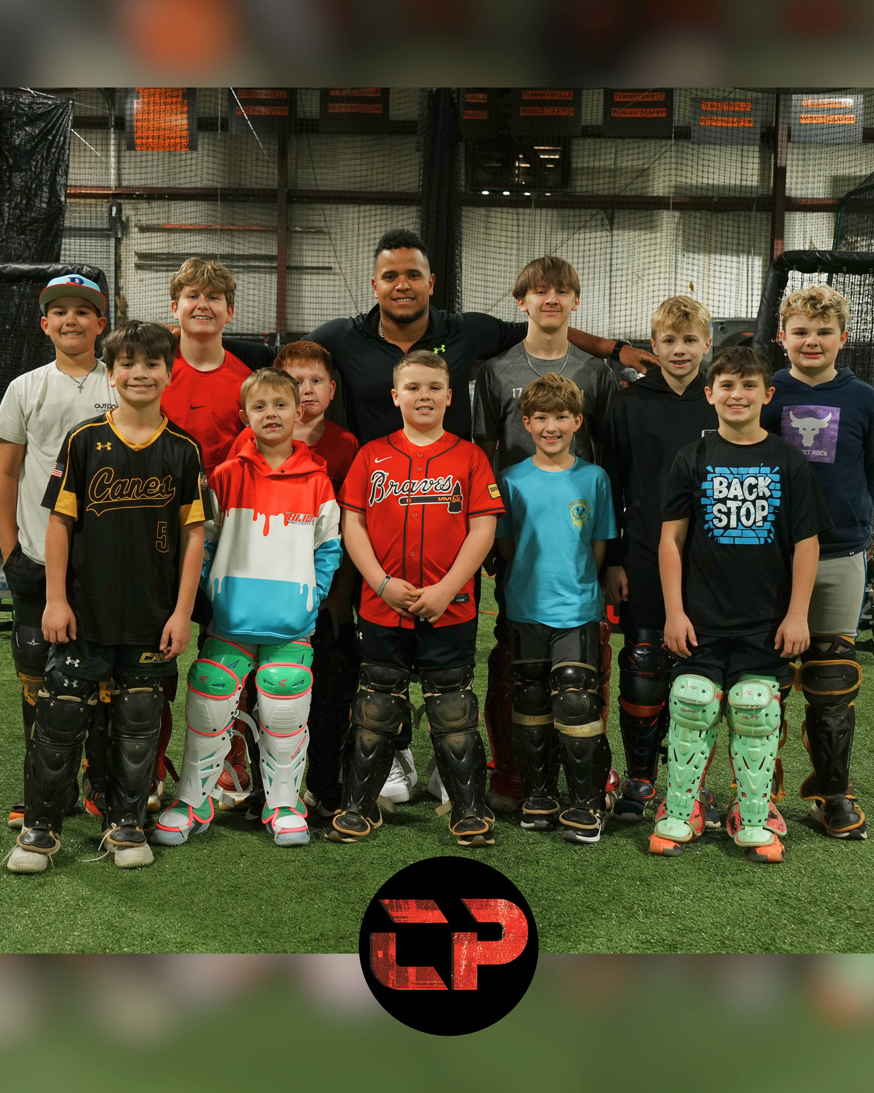Coach Andrés with a group of young catchers after a CATCHPRO ACADEMY clinic