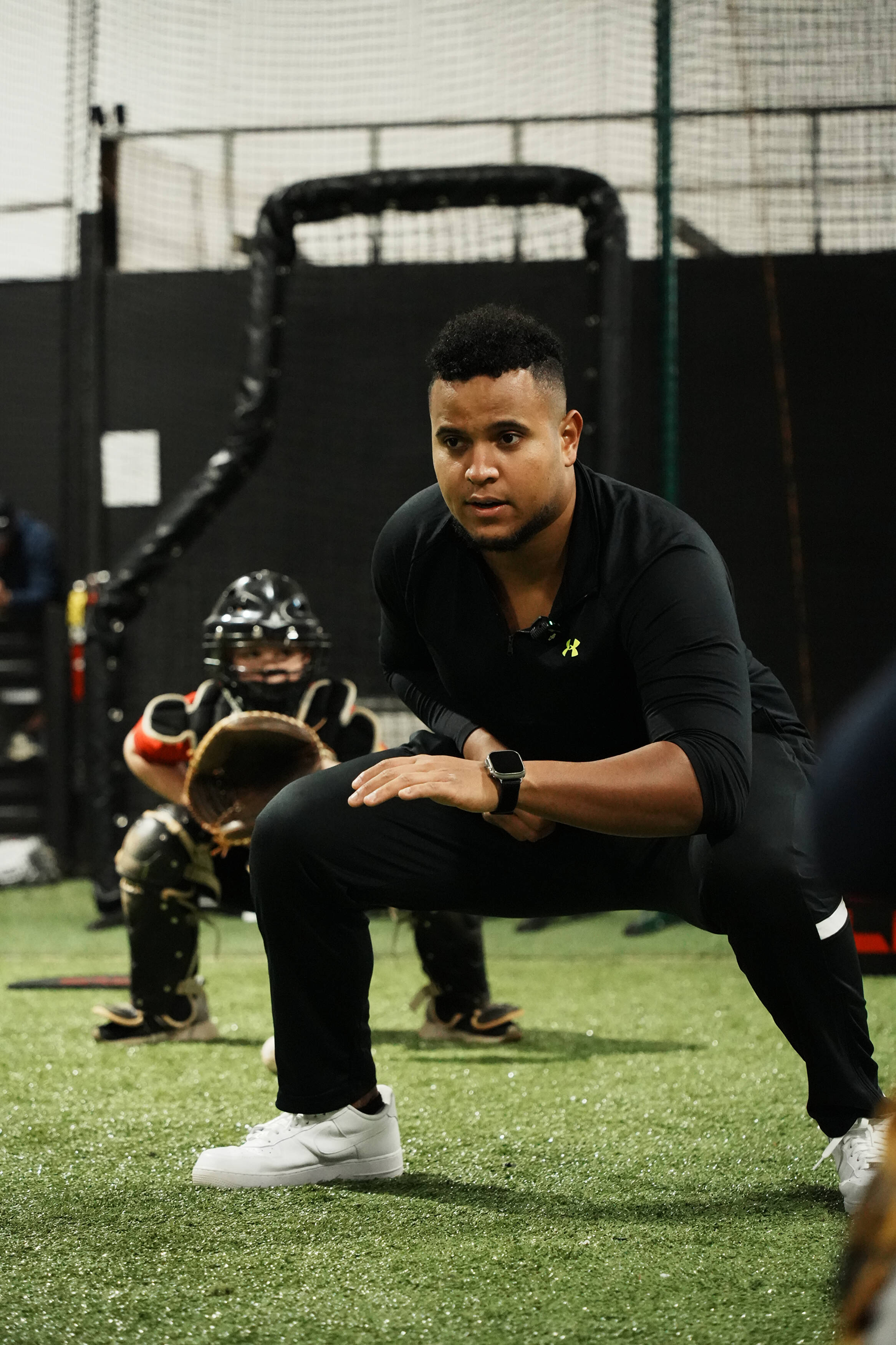 Coach Andrés demonstrating catcher movement during training